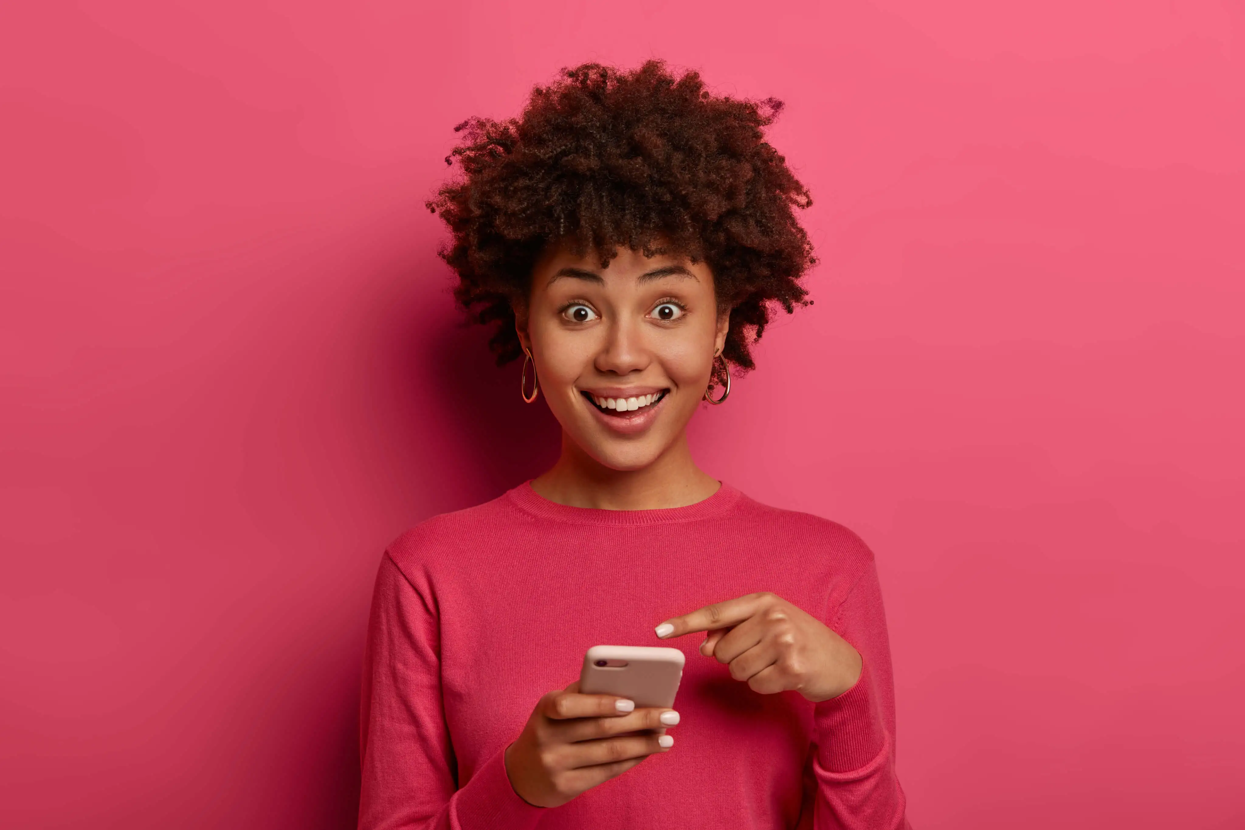 Smiling person holding a phone